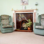 Pine Room - Fireplace and armchairs