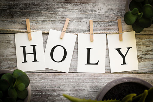 The letters of HOLY printed on cards